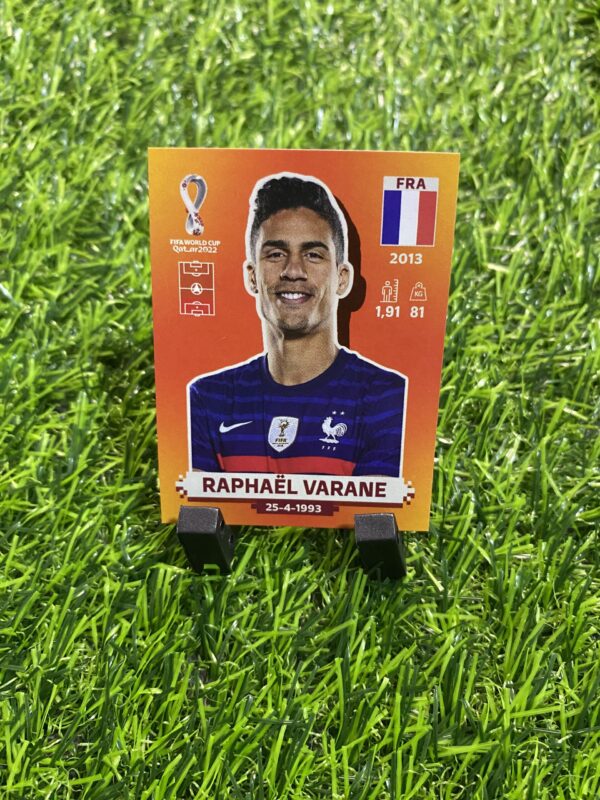 LARANJA: Figurinha do Varane (FRA09)- Álbum Copa do Mundo 2022 (Made in Italy)